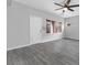 Living room with gray wood floors, natural light, and access to the front entry and a side yard at 2231 Desert Prairie St, Las Vegas, NV 89135