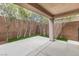 Enclosed patio area with concrete flooring and a garden bed along the brick wall for outdoor relaxation at 2231 Desert Prairie St, Las Vegas, NV 89135