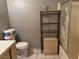 Bathroom with tile flooring, storage shelves, and a toilet at 2425 Paradise Village Way, Las Vegas, NV 89120