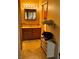 Bathroom featuring a wooden vanity, illuminated mirror, and linoleum flooring at 2425 Paradise Village Way, Las Vegas, NV 89120
