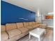 Spacious living room with sleek floors, blue accent wall, open to the kitchen at 2451 N Rainbow Blvd # 2067, Las Vegas, NV 89108