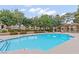 Inviting community pool with mature landscaping, lounge seating, and a covered pergola at 2451 N Rainbow Blvd # 2067, Las Vegas, NV 89108