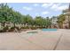 Well-maintained community pool and spa area with lounge chairs and mature trees at 2451 N Rainbow Blvd # 2067, Las Vegas, NV 89108