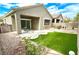 Landscaped backyard with patio and artificial grass, perfect for outdoor entertaining at 2575 Evening Twilight Ave, Henderson, NV 89044