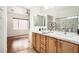 Bright bathroom with a double sink vanity, granite counters, and a separate shower at 2575 Evening Twilight Ave, Henderson, NV 89044