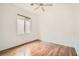 Well-lit bedroom with wood floors, ceiling fan, and a large window at 2575 Evening Twilight Ave, Henderson, NV 89044