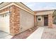 Charming home exterior featuring brick accents, desert landscaping, and a two-car garage at 2575 Evening Twilight Ave, Henderson, NV 89044
