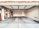 Spacious garage with concrete floor, storage shelves, and overhead racks at 2575 Evening Twilight Ave, Henderson, NV 89044