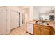 Convenient kitchen featuring white appliances, tile flooring, and view of the living room at 2575 Evening Twilight Ave, Henderson, NV 89044