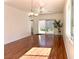 Spacious living room featuring gleaming hardwood floors and sliding glass doors to the back patio at 2575 Evening Twilight Ave, Henderson, NV 89044