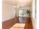 Bright living room featuring wood floors, chandelier, and sliding glass door to patio at 2575 Evening Twilight Ave, Henderson, NV 89044