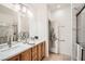 Bright bathroom with double sinks, marble countertop, glass enclosed shower, and ample lighting at 2575 Evening Twilight Ave, Henderson, NV 89044