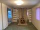 View of the living room with a fireplace, shelving and window at 3100 Sequoia Ave, Las Vegas, NV 89101