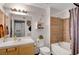 Bright bathroom featuring a tub-shower combo with decorative brown tile and a classic vanity at 3125 N Buffalo Dr # 1105, Las Vegas, NV 89128