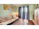 Stylish bedroom with wood floors and a futon near patio doors leading to outdoor living space at 3125 N Buffalo Dr # 1105, Las Vegas, NV 89128