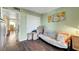 Comfortable bedroom with wood floors and a futon couch with access to additional rooms in the home at 3125 N Buffalo Dr # 1105, Las Vegas, NV 89128