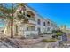 Exterior of a condominium featuring a well-manicured landscape with a mix of greenery and stone elements at 3125 N Buffalo Dr # 1105, Las Vegas, NV 89128