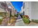 Charming exterior view of townhomes with well-maintained landscaping and a pathway at 3125 N Buffalo Dr # 1105, Las Vegas, NV 89128