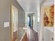 Hallway with wood floors, a large mirror, and access to the laundry room adds style and function at 3125 N Buffalo Dr # 1105, Las Vegas, NV 89128