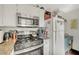 Well-equipped kitchen features stainless steel microwave, gas stove, and granite counters for modern cooking at 3125 N Buffalo Dr # 1105, Las Vegas, NV 89128