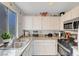 Bright kitchen featuring granite countertops, stainless steel appliances, and white cabinetry for a clean aesthetic at 3125 N Buffalo Dr # 1105, Las Vegas, NV 89128