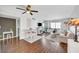 Bright living room featuring wood floors, ceiling fan, dining table, and comfortable seating at 3125 N Buffalo Dr # 1105, Las Vegas, NV 89128