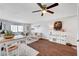 Bright living room featuring wood floors, ceiling fan, and a dining table set at 3125 N Buffalo Dr # 1105, Las Vegas, NV 89128