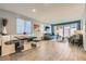 Open concept area with a rustic table surrounded by an airy dining area with plenty of natural light at 320 San Antonio River St, North Las Vegas, NV 89084