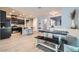 Open dining area with a modern table and bench seating, seamlessly integrated with the kitchen at 320 San Antonio River St, North Las Vegas, NV 89084