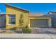 Inviting single-story home with a two-car garage, beautiful landscaping and driveway at 320 San Antonio River St, North Las Vegas, NV 89084