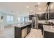 Modern kitchen features dark wood cabinets, granite countertops, stainless appliances, and a center island at 320 San Antonio River St, North Las Vegas, NV 89084