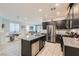Modern kitchen featuring stainless steel appliances, dark cabinetry, and granite countertops at 320 San Antonio River St, North Las Vegas, NV 89084