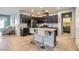 Stylish kitchen with dark cabinets, stainless steel appliances, and a breakfast bar with seating at 320 San Antonio River St, North Las Vegas, NV 89084