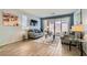 Cozy living room featuring neutral tones, stylish decor, and sliding glass doors to the patio at 320 San Antonio River St, North Las Vegas, NV 89084
