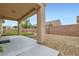 Covered patio with backyard view, featuring a small putting green and rock landscaping at 3220 Flinthead Dr, North Las Vegas, NV 89084