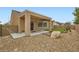 Backyard featuring covered patio, rock landscaping, and small putting green at 3220 Flinthead Dr, North Las Vegas, NV 89084