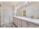 Bathroom featuring double sinks with vanity, modern lighting and a separate glass enclosed shower at 3220 Flinthead Dr, North Las Vegas, NV 89084