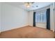 Spacious bedroom featuring a ceiling fan, window with shutters, and neutral carpet at 3220 Flinthead Dr, North Las Vegas, NV 89084