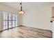 Open dining area with sliding glass doors and contemporary light fixture, enhanced by gray tone flooring at 3220 Flinthead Dr, North Las Vegas, NV 89084