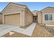Well-maintained single-story home with a two-car garage and desert-style landscaping at 3220 Flinthead Dr, North Las Vegas, NV 89084