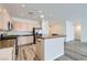 Bright kitchen featuring stainless steel appliances and a breakfast bar, complemented by modern gray tone floors at 3220 Flinthead Dr, North Las Vegas, NV 89084