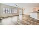 Inviting living space featuring wood-look floors, plantation shutters, and access to the kitchen at 3220 Flinthead Dr, North Las Vegas, NV 89084
