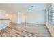 Open-concept living space with wood-look floors, neutral walls, and ample natural light at 3220 Flinthead Dr, North Las Vegas, NV 89084