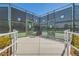 An inviting gated tennis court entrance with green fencing, accessibility ramps and desert landscaping on a sunny day at 3220 Flinthead Dr, North Las Vegas, NV 89084