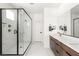 Elegant bathroom featuring a glass shower, double sink vanity, and marble-style tile at 3243 Fountaintree Ave, Henderson, NV 89044