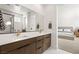 Bathroom featuring a double sink vanity with modern fixtures, marble floors, and shower at 3243 Fountaintree Ave, Henderson, NV 89044