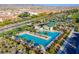 Aerial view of a sparkling community pool, lush landscaping, and shade structures at 3243 Fountaintree Ave, Henderson, NV 89044