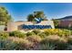 Inspiring community sign with hummingbird logo amid lush landscaping at 3243 Fountaintree Ave, Henderson, NV 89044