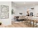 Bright and airy dining room with long table, chairs and bar stools at 3243 Fountaintree Ave, Henderson, NV 89044