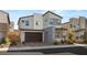 Contemporary two-story home featuring a dark brown two-car garage and stylish gray accents at 3243 Fountaintree Ave, Henderson, NV 89044